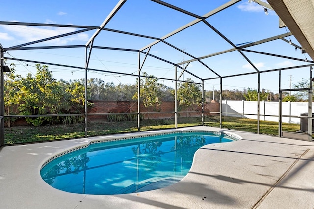 view of swimming pool with a patio and glass enclosure