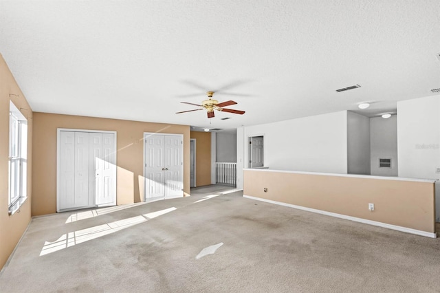 spare room with light carpet and ceiling fan