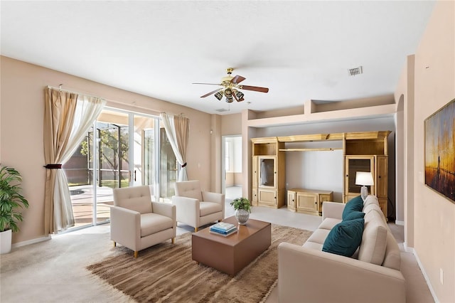 living room featuring light colored carpet and ceiling fan