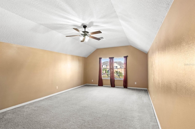 bonus room with a textured ceiling, carpet floors, ceiling fan, and lofted ceiling