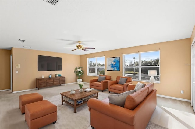 carpeted living room featuring ceiling fan