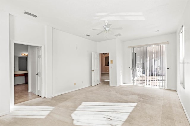 carpeted empty room featuring ceiling fan