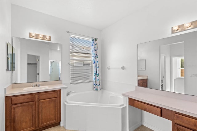 bathroom featuring vanity and tiled tub