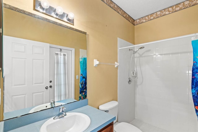 bathroom with curtained shower, vanity, a textured ceiling, and toilet