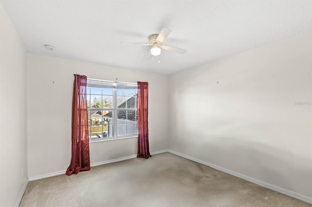 carpeted spare room with ceiling fan