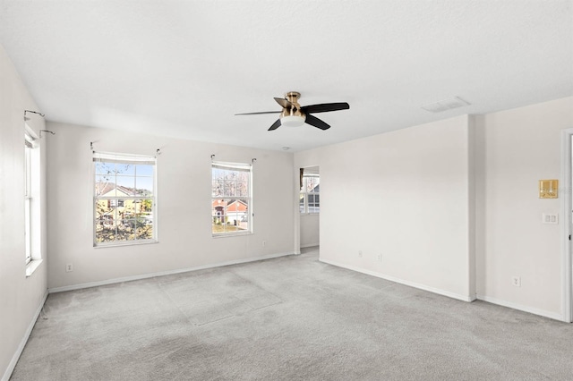 carpeted spare room featuring ceiling fan