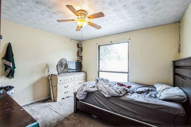 bedroom featuring ceiling fan, a textured ceiling, and carpet flooring