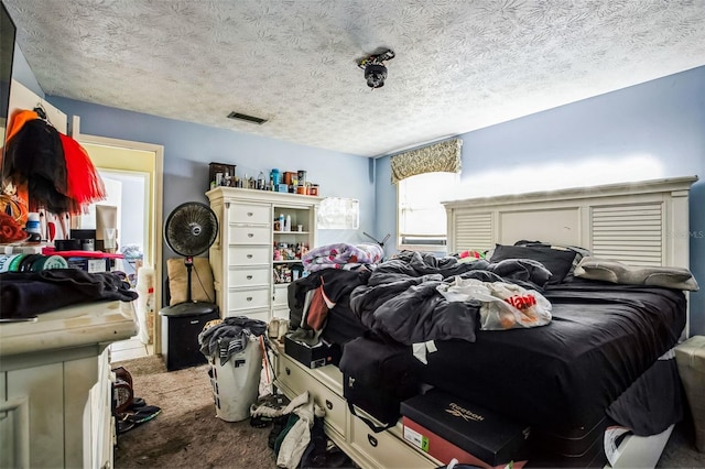 carpeted bedroom featuring a textured ceiling