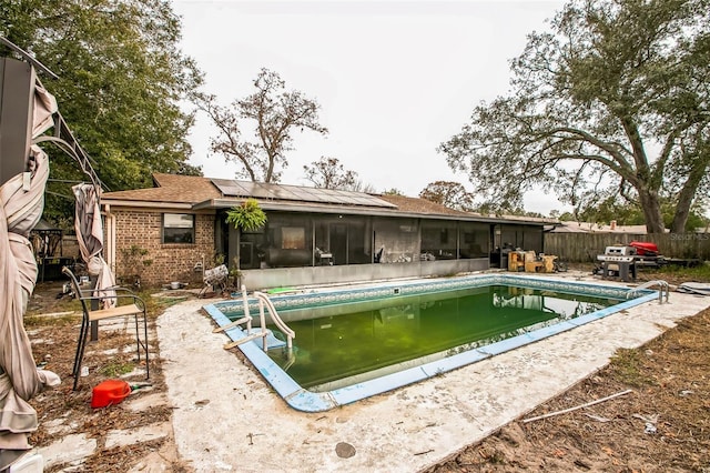 view of pool featuring a sunroom