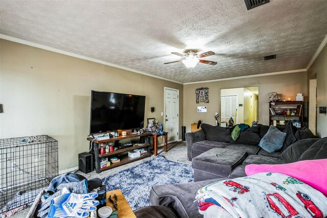 living room with ceiling fan, a textured ceiling, crown molding, and carpet flooring