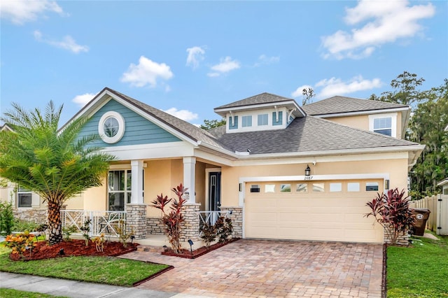 craftsman house with covered porch and a garage