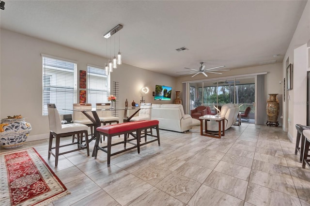 living room with ceiling fan and plenty of natural light