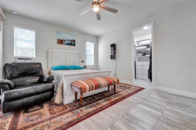 bedroom featuring ceiling fan, cooling unit, and multiple windows