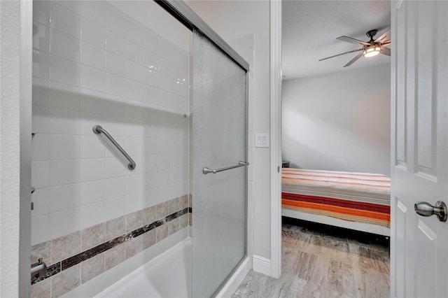 bathroom with a textured ceiling, a shower with door, and ceiling fan