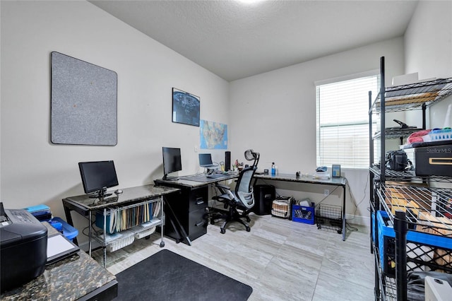 office area with a textured ceiling