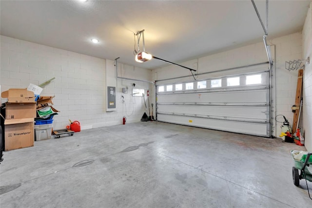 garage featuring electric panel and a garage door opener