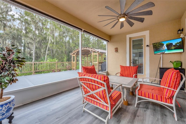 sunroom featuring ceiling fan