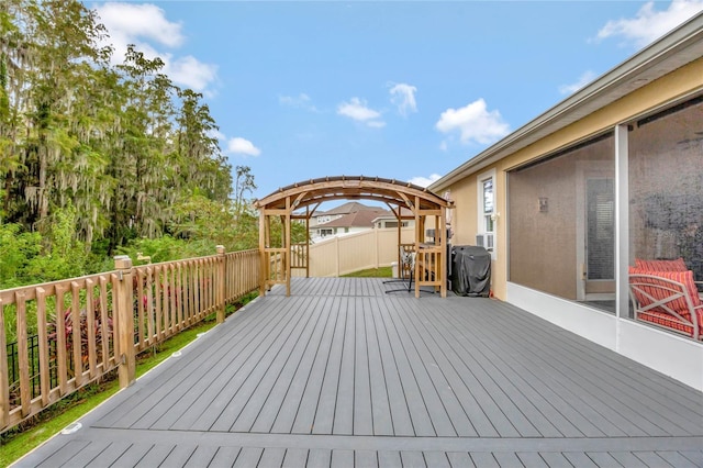 wooden deck featuring a grill