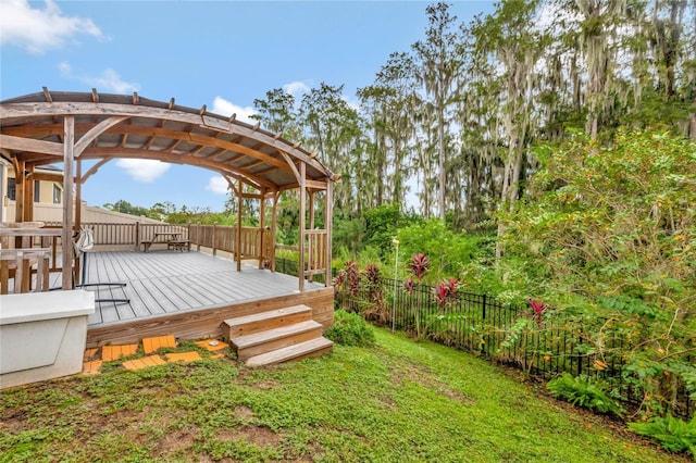 wooden terrace featuring a yard