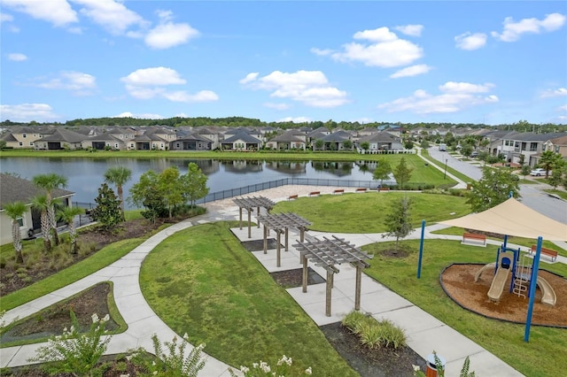 view of home's community with a lawn, a playground, a water view, and a pergola