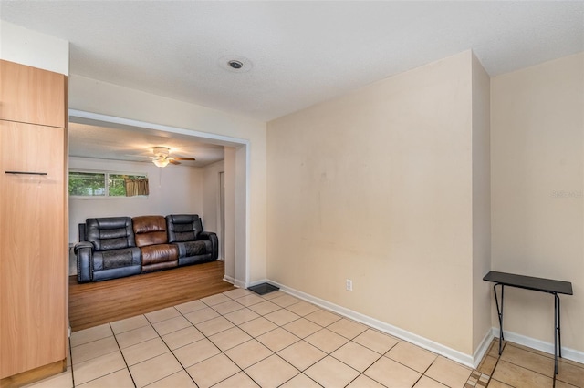 living room featuring ceiling fan and light tile patterned floors