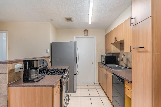 kitchen featuring dishwasher, high end stainless steel range oven, a textured ceiling, light brown cabinetry, and light tile patterned flooring