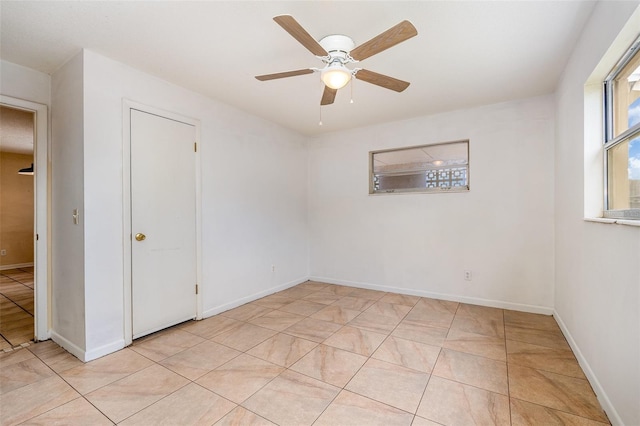 tiled empty room with ceiling fan