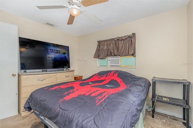 carpeted bedroom with ceiling fan and cooling unit