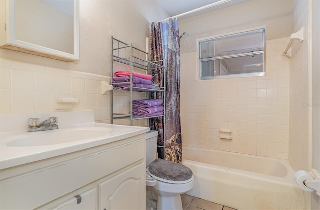 full bathroom featuring shower / bath combo, tile patterned floors, toilet, vanity, and tile walls