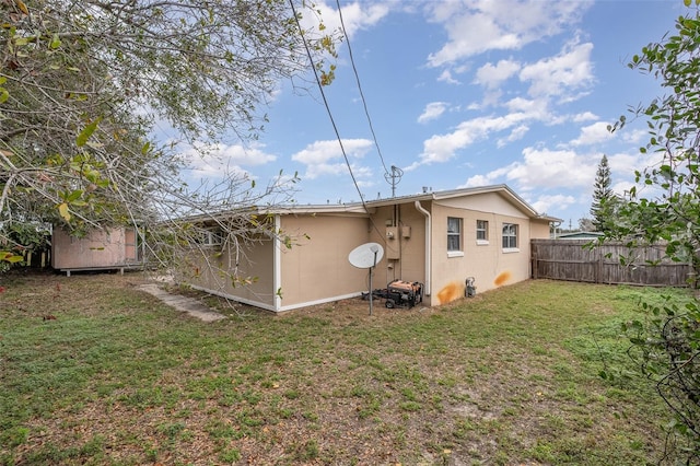 rear view of house featuring a lawn