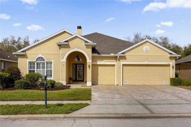 ranch-style house with a garage and a front lawn