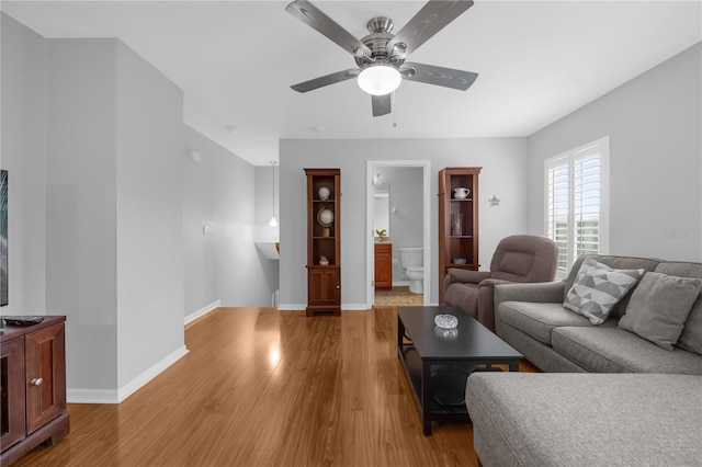 living room featuring hardwood / wood-style floors and ceiling fan