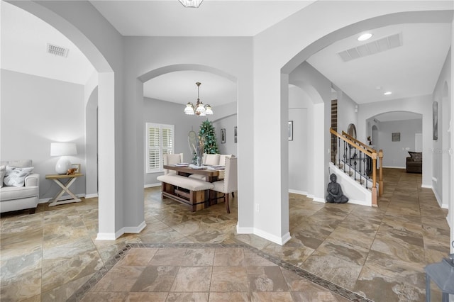 foyer featuring an inviting chandelier