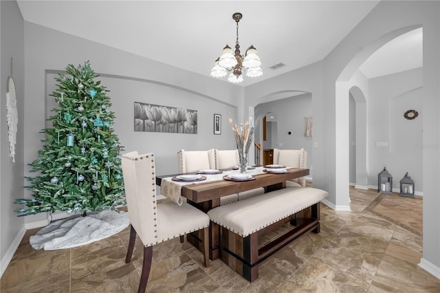 dining space featuring a chandelier