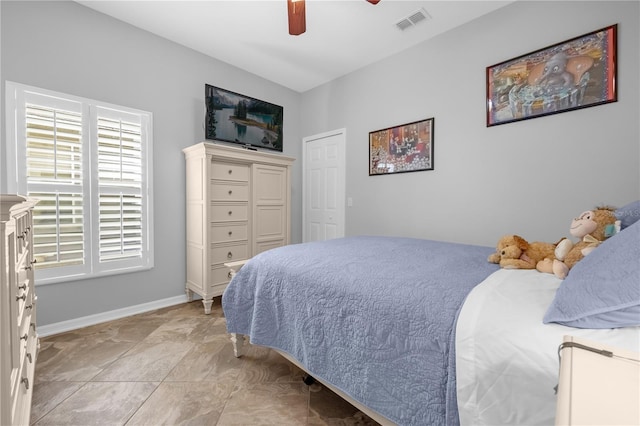 bedroom featuring light tile patterned floors and ceiling fan