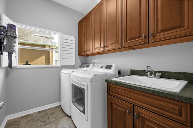 laundry area featuring cabinets, sink, light tile patterned floors, and washer and dryer