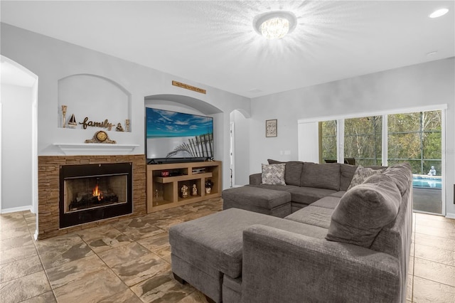 living room featuring a stone fireplace