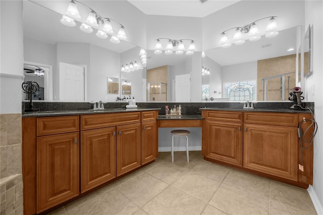 bathroom featuring tile patterned floors, ceiling fan, vanity, and a shower with shower door