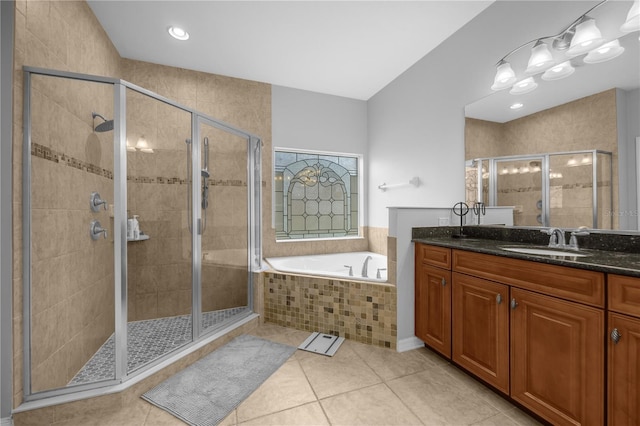 bathroom with plus walk in shower, vanity, and tile patterned floors