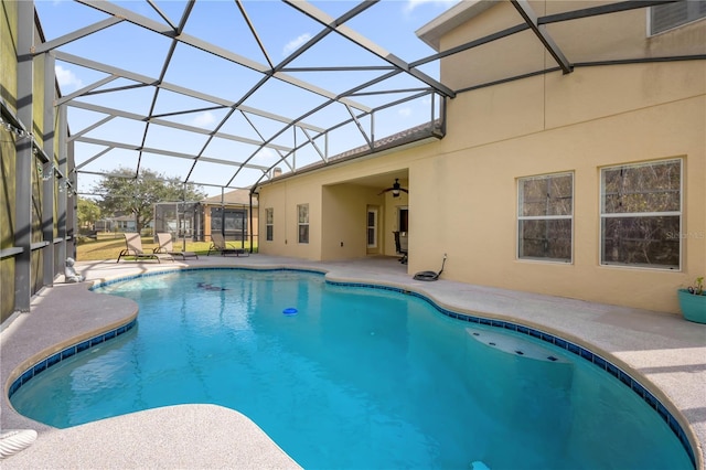 view of swimming pool with a patio area and a lanai