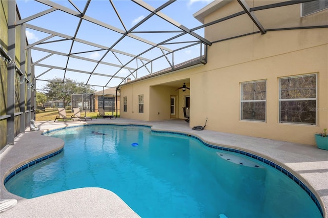 view of swimming pool featuring a patio and glass enclosure