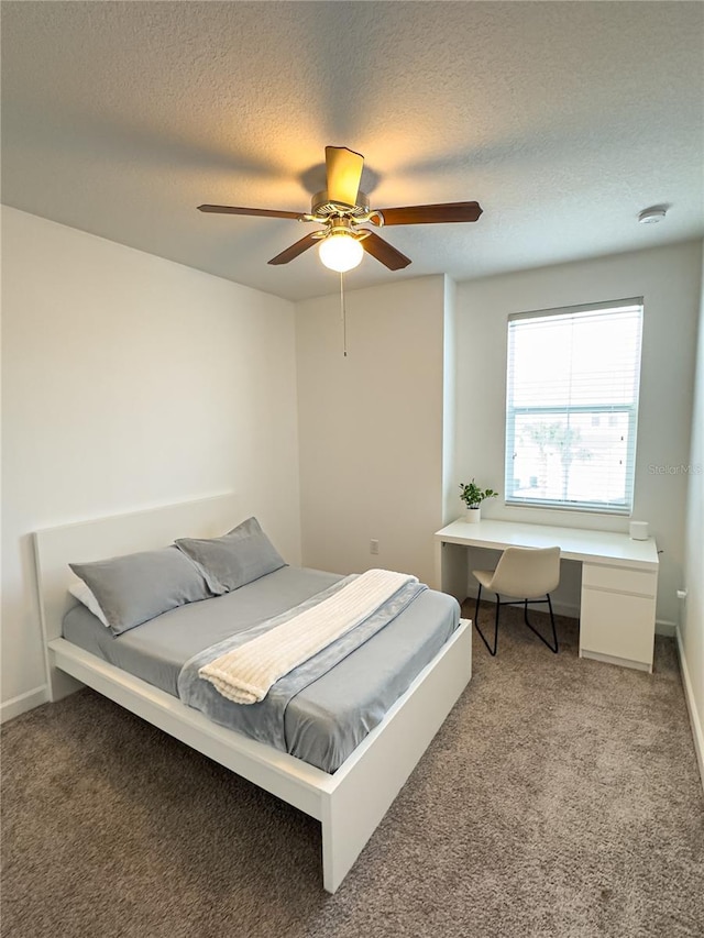 bedroom featuring a textured ceiling, ceiling fan, and carpet flooring