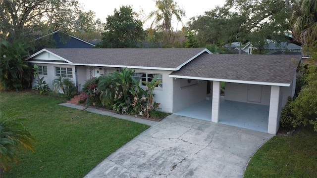 ranch-style home featuring a front yard and a carport