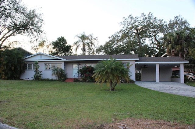 ranch-style house with a front yard, a carport, and ceiling fan