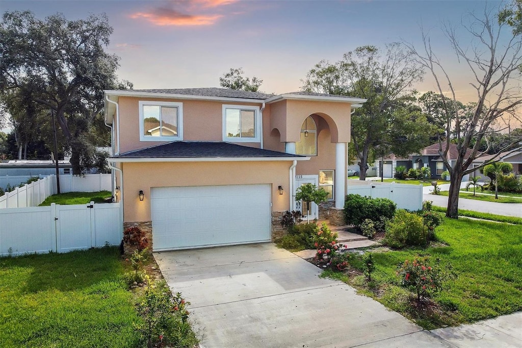 view of front of property with a lawn and a garage