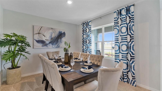 dining area featuring light colored carpet