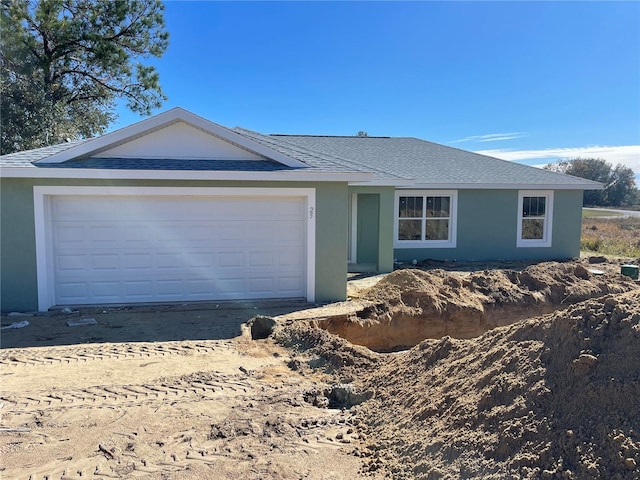 single story home featuring a garage