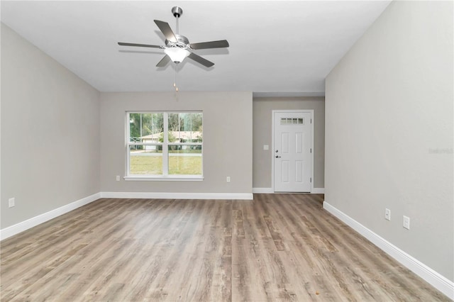 unfurnished living room with ceiling fan and light wood-type flooring