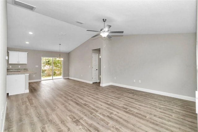 unfurnished living room with ceiling fan, light hardwood / wood-style flooring, and vaulted ceiling