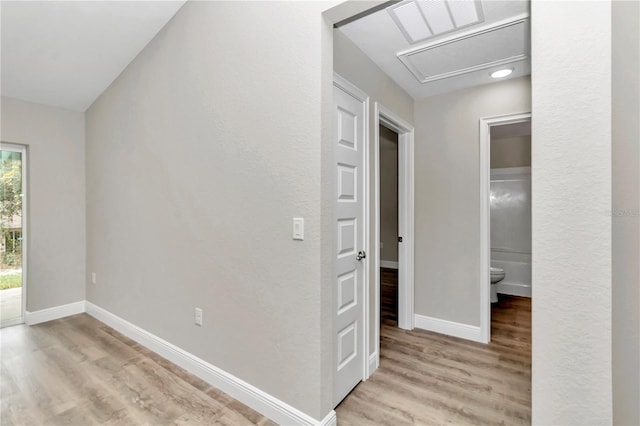 hallway with light hardwood / wood-style floors